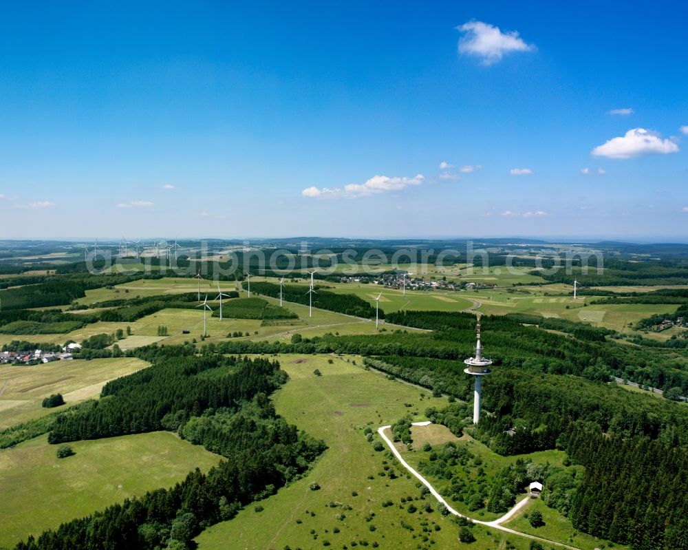 Aerial image Siegen - The Siegerland area with the telecommunication tower on the Eisenhardt mountain in the state of North Rhine-Westphalia. The radio mast is used for cell phone and digital radio signal transmission. In the background are wind power wheels and turbines as well as the surrounding mountain tops of the Rothaar mountain area