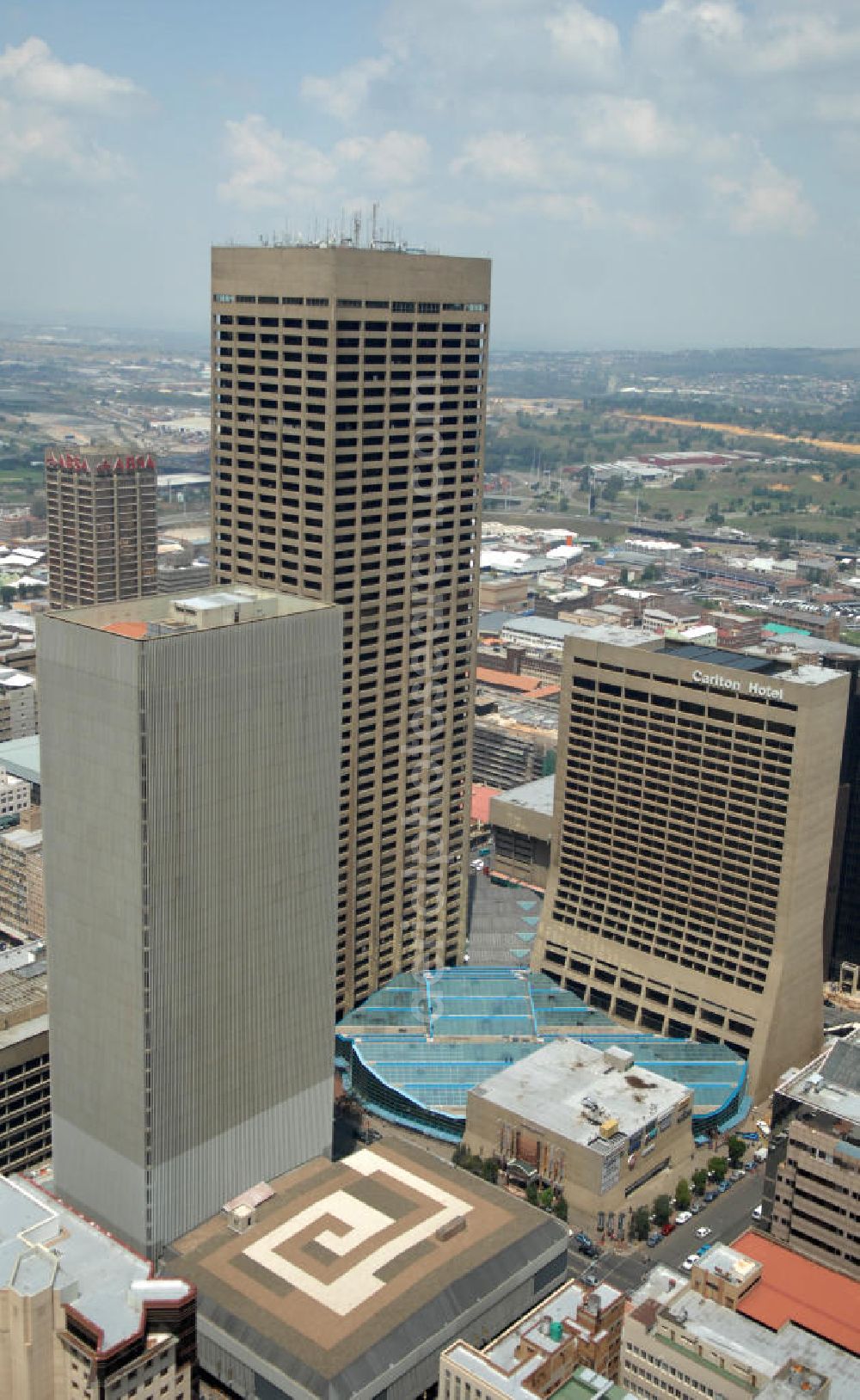 JOHANNESBURG from above - The Carlton Centre consisted of a shipping mall, the Carlton Hotel and an office building. It is abandoned since 1990. The Kine Centre in front consists of several offices and shops, a penthouse on the top floor, a cinema and two basement garages. The two complexes are linked by an underground pedestrian tunnel