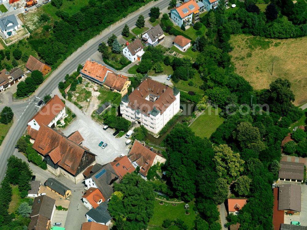 Aerial photograph Ammerbuch - The water castle in the Poltringen part of Ammerbuch in the state of Baden-Württemberg. The square castle is surrounded by a water ditch and lies amidst residential houses, forest and farms