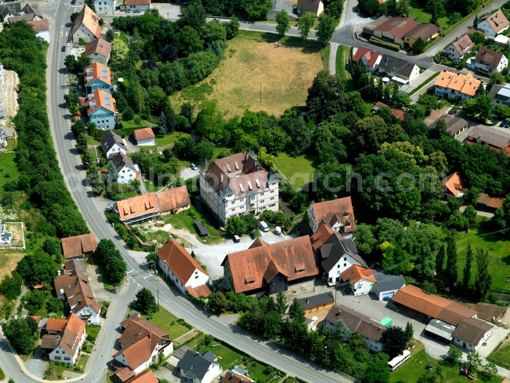 Ammerbuch from above - The water castle in the Poltringen part of Ammerbuch in the state of Baden-Württemberg. The square castle is surrounded by a water ditch and lies amidst residential houses, forest and farms