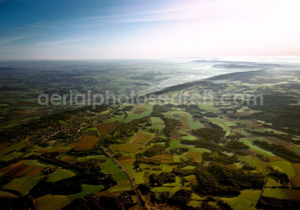 Aerial photograph Ostercappeln - The Wiehen Hills in Ostercappeln in the district of Osnabrück in the state of Lower Saxony. The borough of Ostercappeln can be seen in the foreground, the low mountain range runs off to the East and disappears in the fog. The mountains build a wedge that runs towards the Porta Westfalica