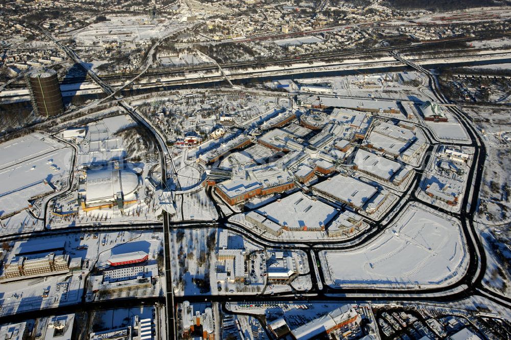 Oberhausen from above - The winterliche CentrO is one of the largest shopping centers and urban entertainment center in Germany. It forms the core of the new center of Oberhausen. Over 250 retail shops spread out geographically in different areas, arranged on two floors of the mall. On the outside is a promenade, a multiplex cinema and the König Pilsener Arena. In the background is the industrial memorial Gasometer