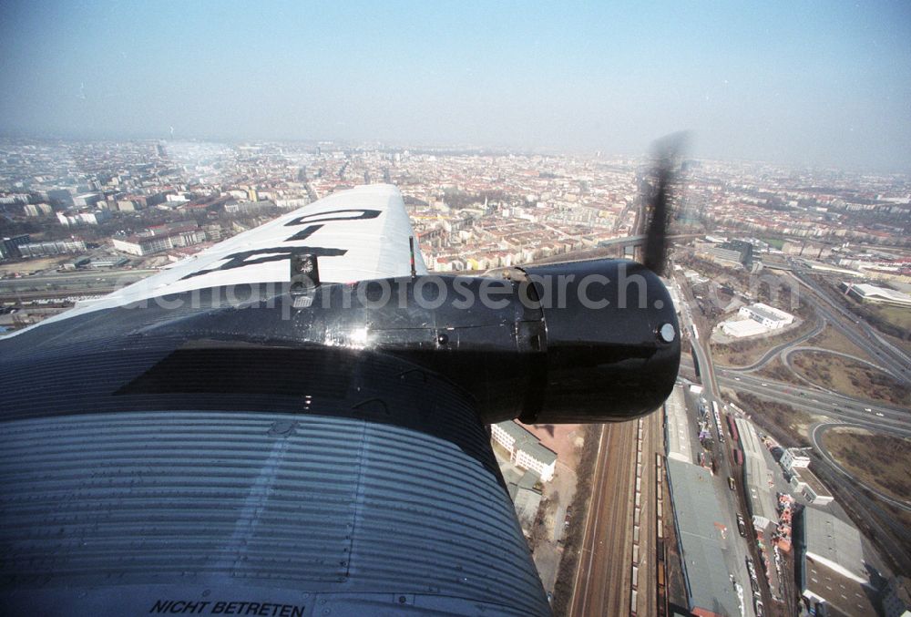 Berlin-Tempelhof from above - Das Traditionsflugzeug der Lufthansa, die „Tante Ju“ (offiziell „Junkers 52“) mit dem Namen „Berlin-Tempelhof“, fliegt über der Berliner Innenstadt (Aufnahme vom 23.04.1996). Das wohl berühmteste Flugzeug Deutschlands feiert seinen 75. Geburtstag. Am 06.04.1936 lief die D-AQUI traditionelles Oldtimer-Luftfahrtkennzeichen) in den Dessauer Junkers-Werken vom Band.