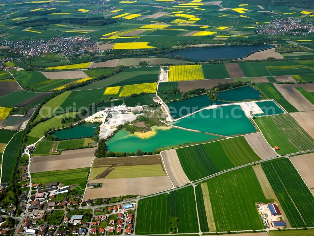 Ehingen from the bird's eye view: The quarry pond in the Rißtissen part of Ehingen in the state of Baden-Württemberg. The lake is located in an area of agricultural fields on the Northern border of Rißtissen. The region is characterised by the river Danube and is used for fishing and as a bathing lake