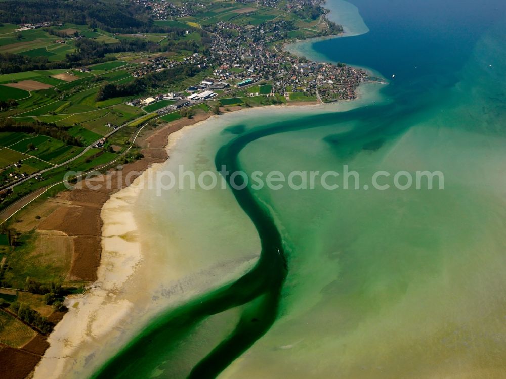 Konstanz from above - The Lake Constance at the mouth of the river Rhine near Constance in the state of Baden-Württemberg. The varied coloration of the water of the river and the lake is distinguishable. This part of Lake Constance is the larger Obersee. The riverbank consists of gravel and sand, a natural barrier to the fields and acres