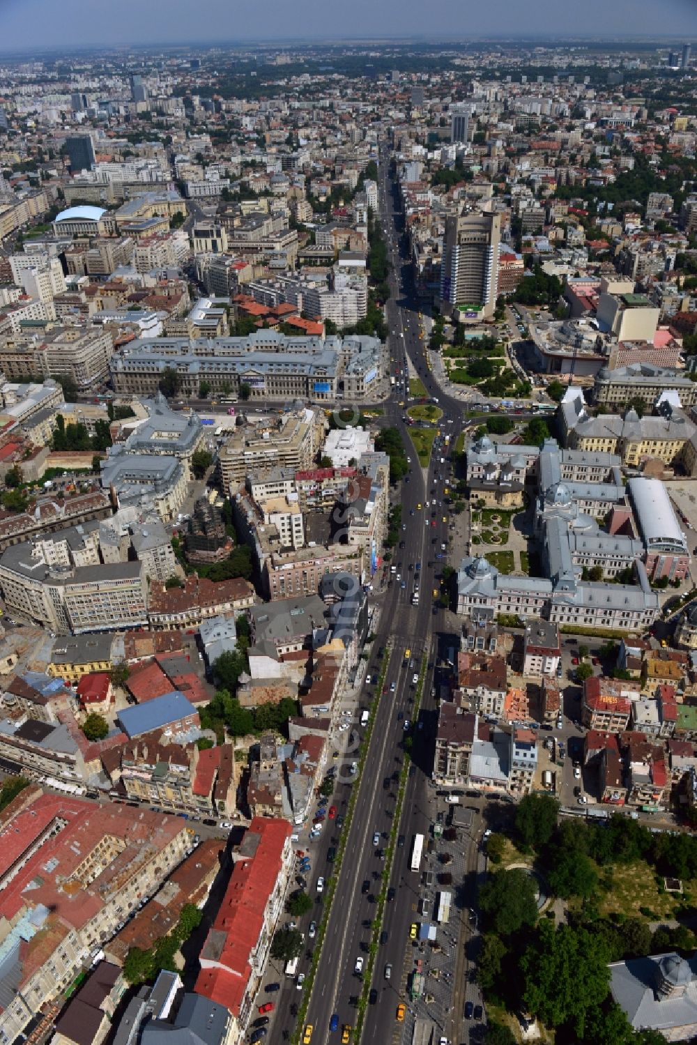 Bukarest from the bird's eye view: The Bulevardul Ion C. Bratianu and the University Square in downtown Bucharest in Romania. View from the South towards the square. On the square there are the University of Bucharest main building, the National Theatre and the Hospital Coltea on the East side of the Boulevard. The hospital is the oldest of the city, completed in 1703. It is also home to a church