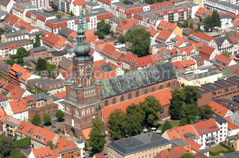 Aerial image Greifswald - Blick auf den Dom St. Nikolai. Der gotische Backsteinbau ist das Wahrzeichen der Stadt und wird im Volksmund Langer Nikolaus genannt. Der Dom stammt aus dem 13. Jahrhundert. Der Turm ist ca. 100 m hoch und begehbar, das Dach besteht aus Kupfer und hat die Form einer verdoppelten Zwiebelkuppel. Kontakt: Evangelische Kirchengemeinde St. Nikolai, Domstraße 54, 17489 Greifswald, Tel. 03834 / 2627, st.nikolai@kirchenkreis-greifswald.de