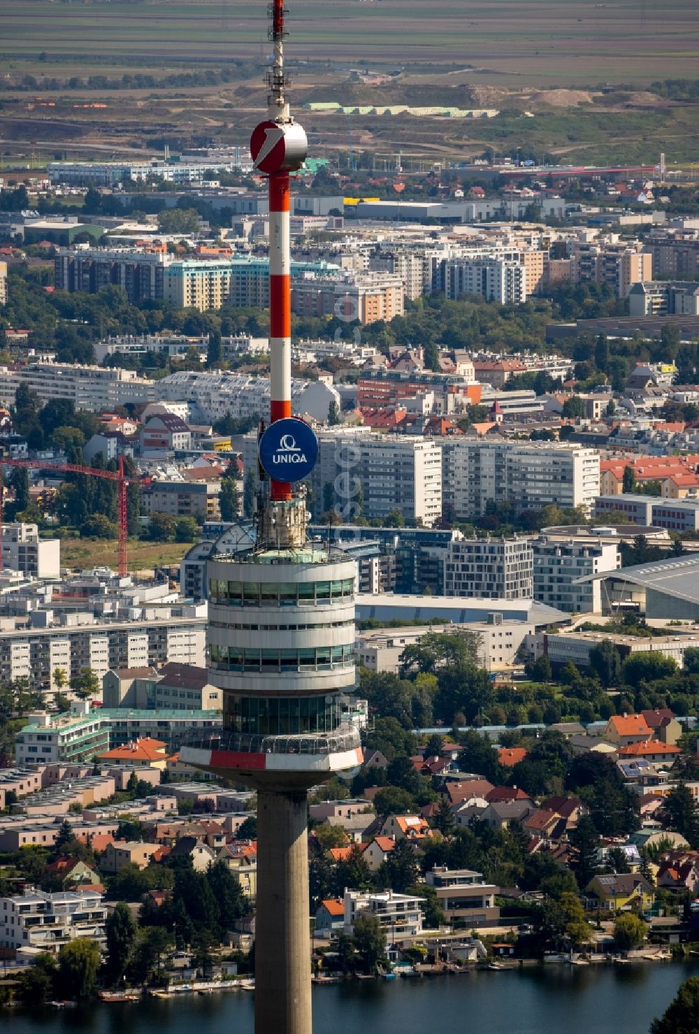 Wien from above - View of the viewing platform and the antenna of the Donauturm in front of the scenery of Vienna on the oxbow lake Alte Donau of the Danube in Austria