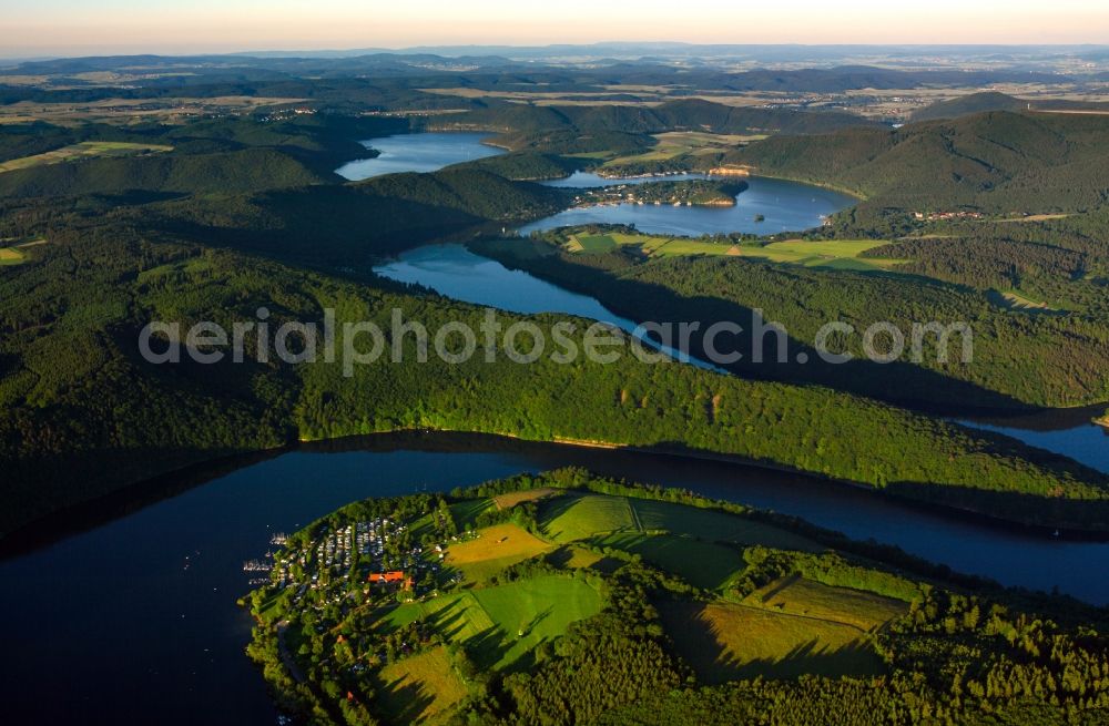 Aerial image Vöhl - The lake Edersee in the borough of Vöhl in the state of Hesse. The lake, a barrier lake and water reservoir, is the second largest of its kind in Germany. It is located at the river Eder at the connection with the river Fulda behind a 48m concrete dam and in the Nature Park Kellerwald-Edersee. It forms a large recreational and leisure region with its surrounding area