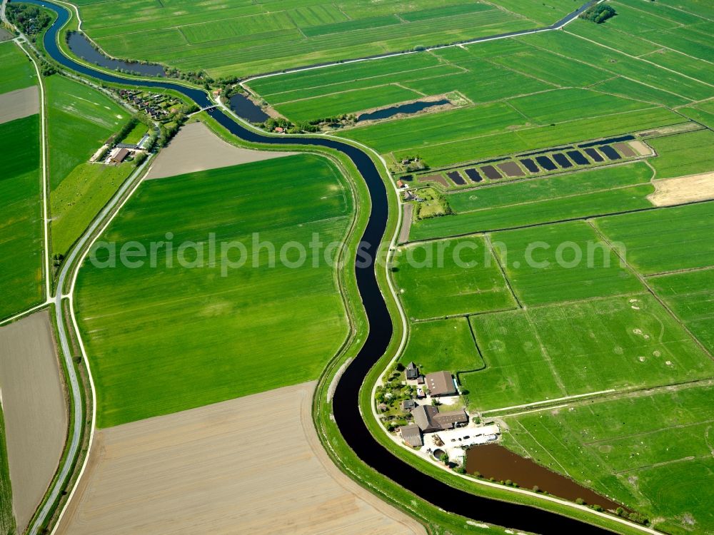 Emden from the bird's eye view: The Ems-Jade-Channel in Emden in the region of Ostfriesland in the state of Lower Saxony. The channel connects the river Ems with the seaside area of the Jade. It is mainly responsible for draining the region. It runs alongside various farms and fields