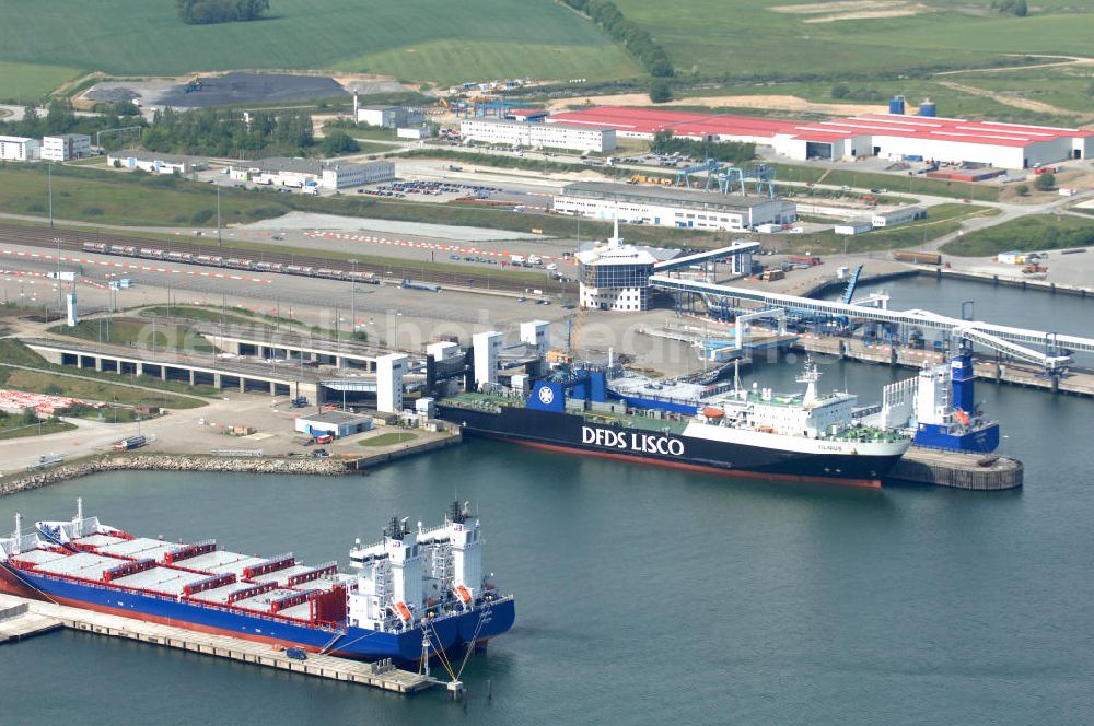 Aerial photograph Sassnitz - Blick auf den Fährhafen Mukran. Der Fährbahnhof liegt an der Ostseite der Insel Rügen und verfügt neben den acht Liegeplätzen auch einen Gleisanschluss für die Fähren nach Schweden. Er bietet Fährverbindungen nach Trelleborg, St. Petersburg und Klaipedia in Litaun. Darüber hinaus bietet er auch eine Anlegemöglichkeit für Kreuzfahrtschiffe. Der ursprüngliche Fährhafen befand sich in Sassnitz, wurde aber in den 1980erJahren in den Ortsteil Mukran verlegt um den Güterverkehr nach Litaun zu beschläunigen. Der Fährbahnhof Mukran ist der größte in Deutschland und der drittgrößte deutsche Ostseehafen. Betrieben wird er von der Reederei Scandlines. Kontakt: Scandlines Deutschland GmbH, Tel. 01805 / 11 66 88. Kontakt: Fährhafen Sassnitz GmbH, Fährhafen Sassnitz, 18546 Sassnitz / Neu-Mukran, Tel. 038392 / 55 0, info@faehrhafen-sassnitz.de