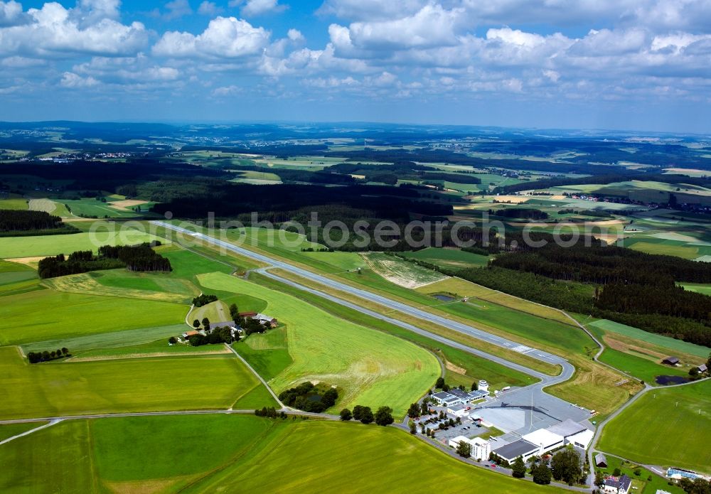 Hof an der Saale from above - The airport Hof-Plauen near Hof an der Saale in the state of Bavaria. The commercial airport was strongly frequented in the 1970s, 80s and 90s for scheduled and chartered flights. Today, the Fair Air company provides chartered flights in a air taxi way. There is also a flight school on site