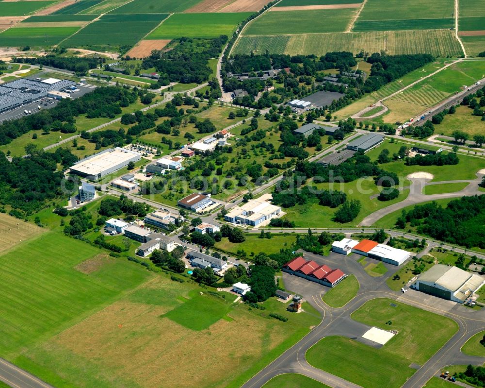 Bremgarten from above - The airfield and industrial area Bremgarten in the Breisgau region of the state of Baden-Württemberg. The area is a former military airfield. Today it is a nature preserve. View of the runway as well as hangar and various halls