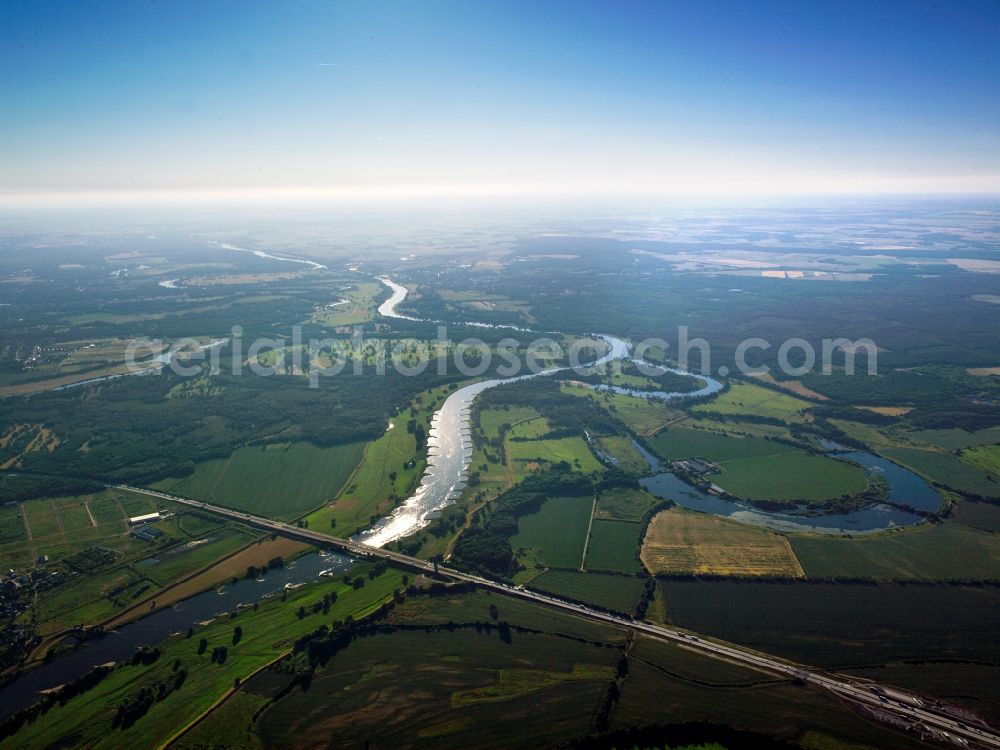 Aerial image Coswig - The river Elbe and the old Elbe in Coswig in the state of Saxony-Anhalt. The river runs between fields through the landscape. The visible horse-shoe-bend, which is only slightly watered, is part of the old Elbe. Visible as well is the highway A9 crossing the river