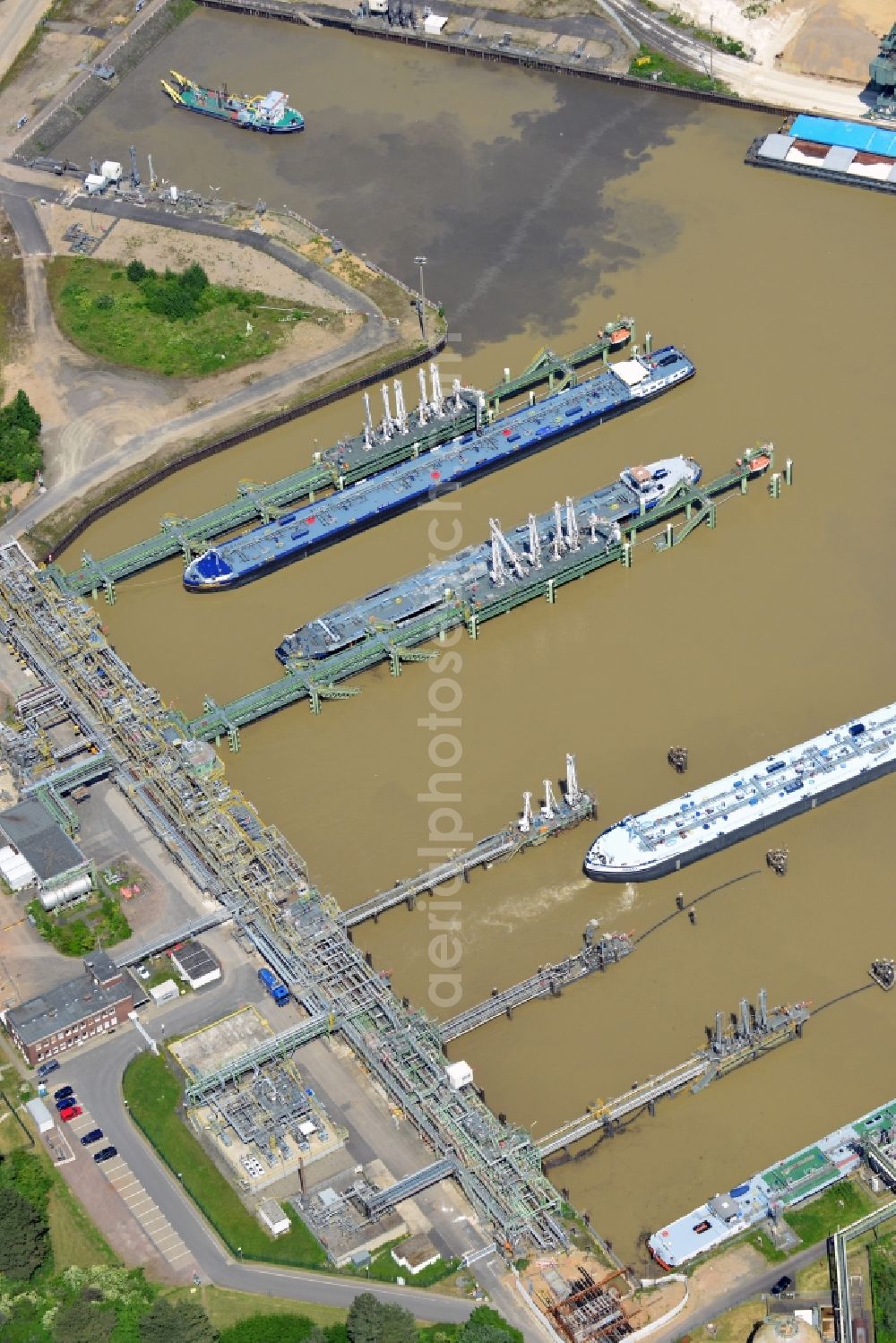 Aerial photograph Köln - The port of Cologne - Godorf in the state of North Rhine-Westphalia. The harbour is the most frequented harbour in Cologne on the river Rhine. The main goods transferred here are mineral oil and brown coal. View of transport ships in the harbor and wharf