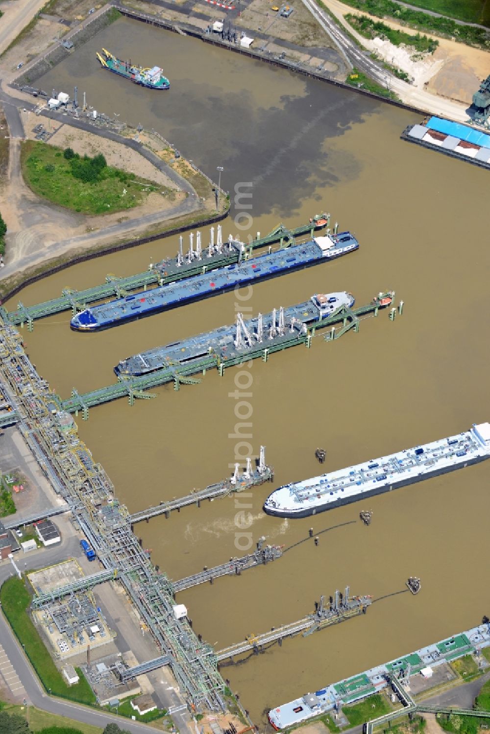 Köln from above - The port of Cologne - Godorf in the state of North Rhine-Westphalia. The harbour is the most frequented harbour in Cologne on the river Rhine. The main goods transferred here are mineral oil and brown coal. View of transport ships in the harbor and wharf