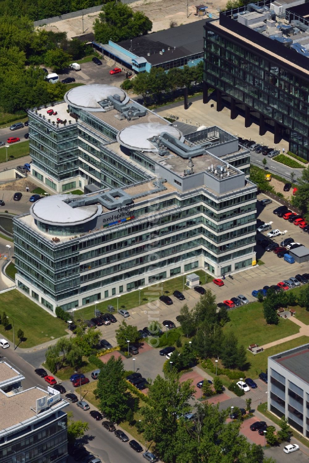 Warschau from above - The headquarters of Ringier Axel Springer Media AG in the Mokotow district of Warsaw in Poland. The joint venture of the German and Swiss publishing houses has been created in 2010 and is located in the rectangular building in the Southwest of the district. The facility is surrounded by other office low rise buildings in the Sluzewiec part of the district