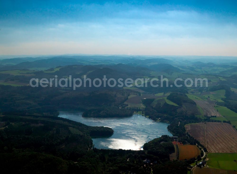 Aerial image Hennesee - The lake Hennesee in the Sauerland region of the state of North Rhine-Westphalia. The lake was created through the Henne valley dam, which blocks the river Henne. It is located in the nature reserve Homert. The Hennesee is used for swimming and diving. In summer it is frequented by a tourist boat