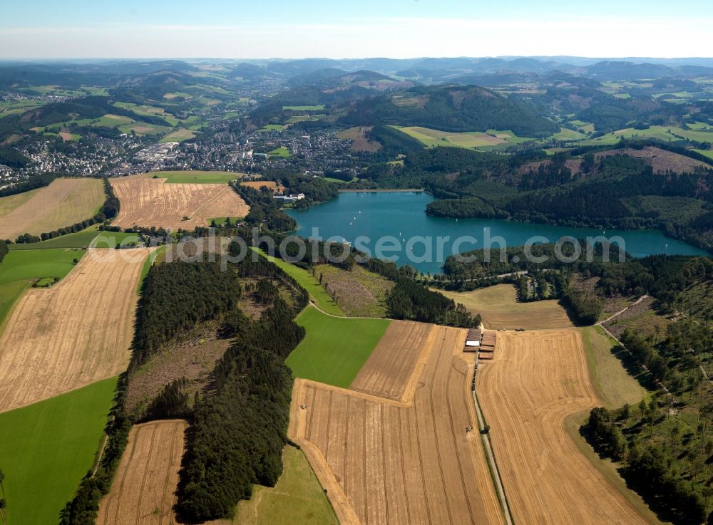 Hennesee from above - The lake Hennesee in the Sauerland region of the state of North Rhine-Westphalia. The lake was created through the Henne valley dam, which blocks the river Henne. It is located in the nature reserve Homert. The Hennesee is used for swimming and diving. In summer it is frequented by a tourist boat