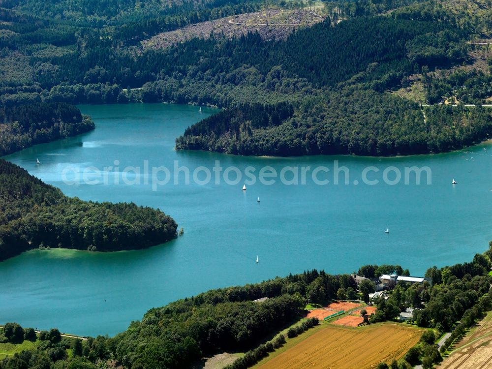 Hennesee from the bird's eye view: The lake Hennesee in the Sauerland region of the state of North Rhine-Westphalia. The lake was created through the Henne valley dam, which blocks the river Henne. It is located in the nature reserve Homert. The Hennesee is used for swimming and diving. In summer it is frequented by a tourist boat