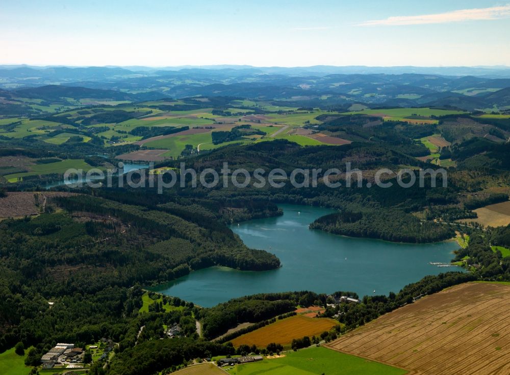 Aerial image Hennesee - The lake Hennesee in the Sauerland region of the state of North Rhine-Westphalia. The lake was created through the Henne valley dam, which blocks the river Henne. It is located in the nature reserve Homert. The Hennesee is used for swimming and diving. In summer it is frequented by a tourist boat