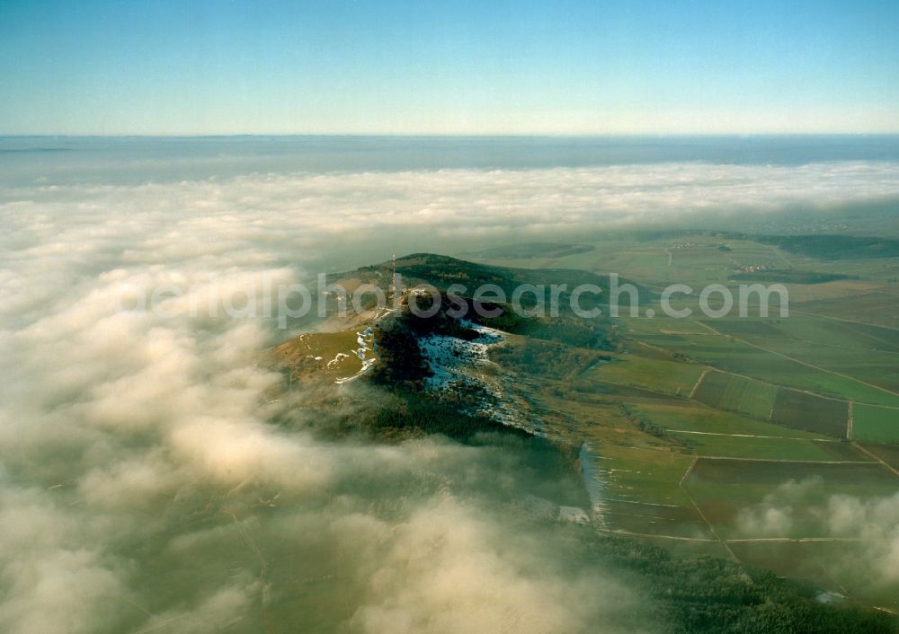 Aerial photograph Wassertrüdingen - The Hesselberg mountain in the region of Middle Franconia in the state of Bavaria. The mountain is the highest top of the region. It is 6km long and covered by forest. It stands among fog and clouds