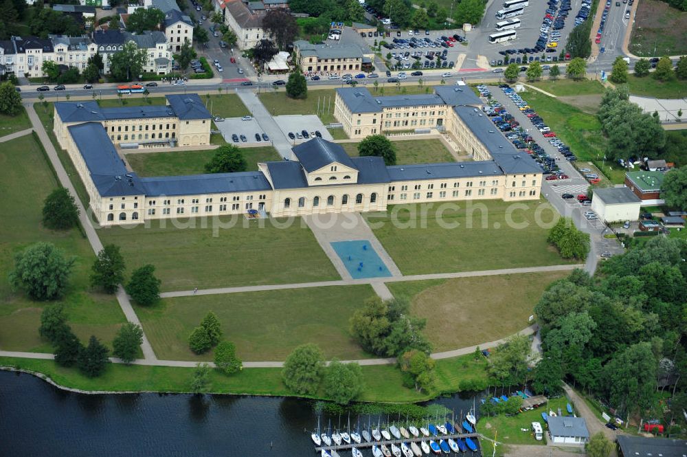 Schwerin from the bird's eye view: Blick auf den historischen Marstall in Schwerin. Das aufwendig restaurierte Gebäude befindet sich auf einer Landzunge an der Werderstraße. Er wurde 1837 - 1842 nach Plänen von G. A. Demmler erbaut und diente als Pferdestall und Reithalle für die herzoglichen Pferde. Seit 1997 werden Teile des Gebäudes vom Technischen Museum genutzt. In den Seitenflügeln sind das Sozialministerium und das Ministerium für Bildung, Wissenschaft und Kultur untergebracht. View of the historical marstall in Schwerin.