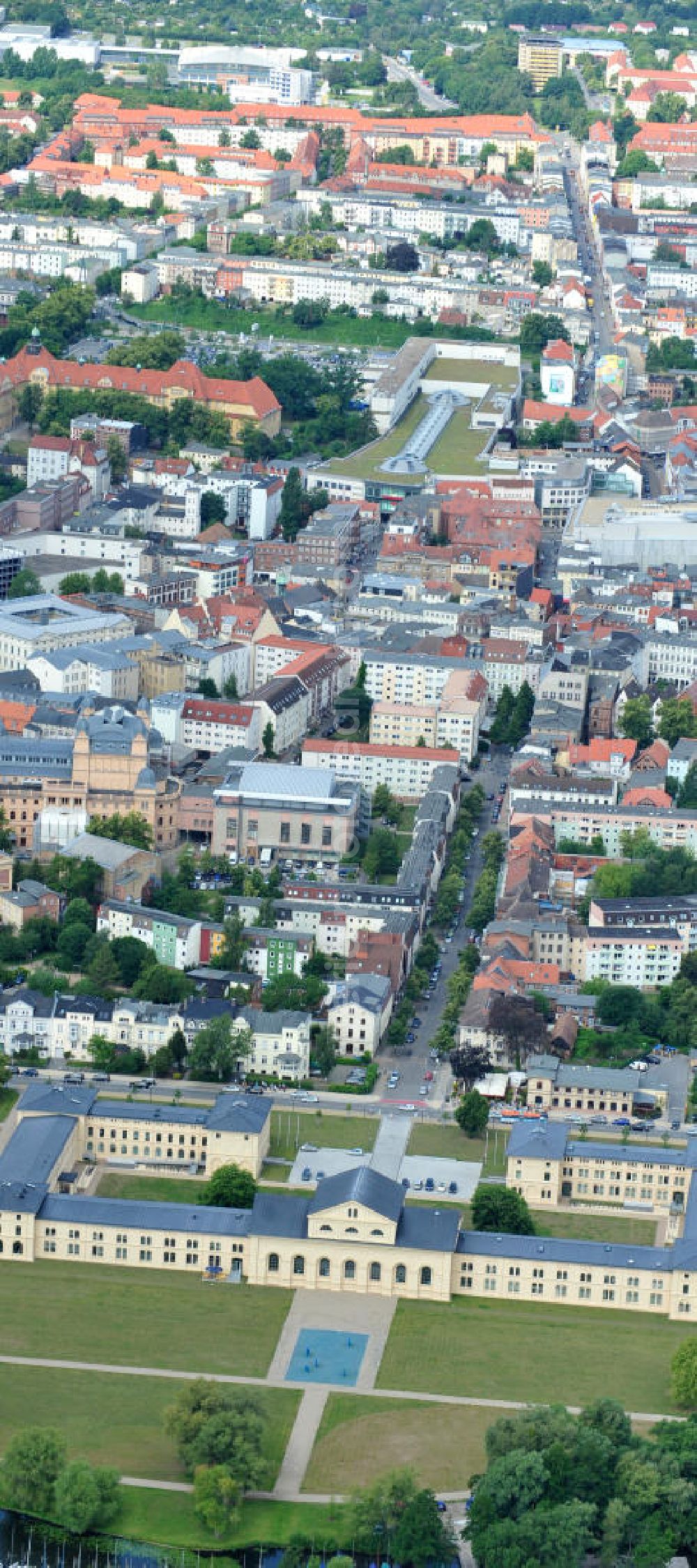 Schwerin from above - Blick auf den historischen Marstall in Schwerin. Das aufwendig restaurierte Gebäude befindet sich auf einer Landzunge an der Werderstraße. Er wurde 1837 - 1842 nach Plänen von G. A. Demmler erbaut und diente als Pferdestall und Reithalle für die herzoglichen Pferde. Seit 1997 werden Teile des Gebäudes vom Technischen Museum genutzt. In den Seitenflügeln sind das Sozialministerium und das Ministerium für Bildung, Wissenschaft und Kultur untergebracht. View of the historical marstall in Schwerin.