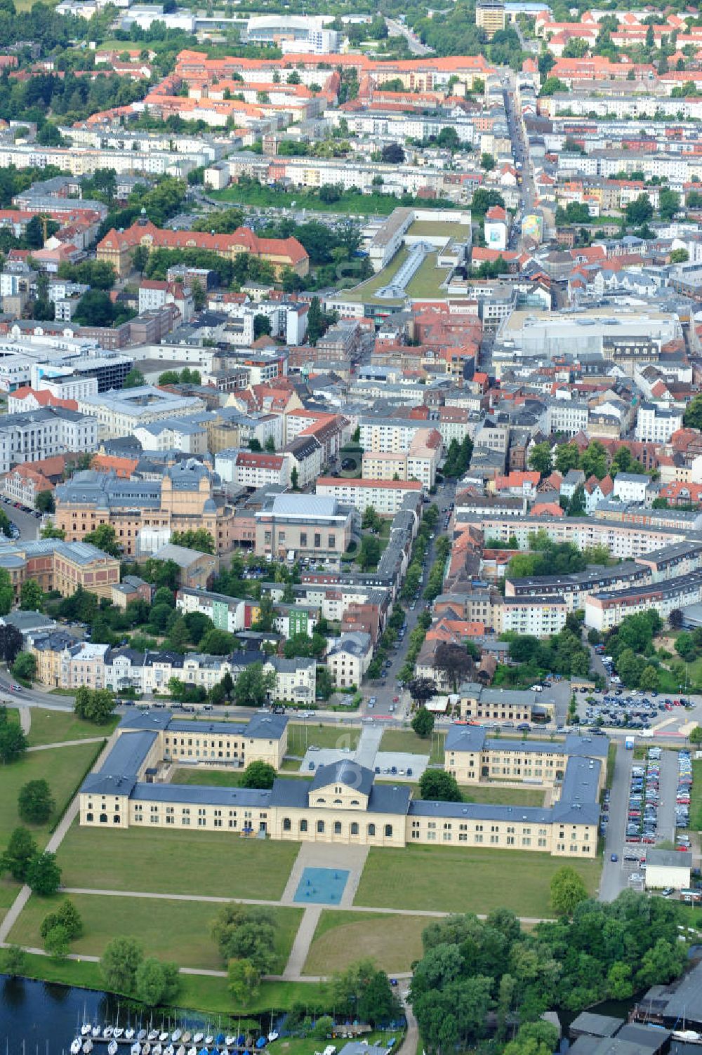 Schwerin from the bird's eye view: Blick auf den historischen Marstall in Schwerin. Das aufwendig restaurierte Gebäude befindet sich auf einer Landzunge an der Werderstraße. Er wurde 1837 - 1842 nach Plänen von G. A. Demmler erbaut und diente als Pferdestall und Reithalle für die herzoglichen Pferde. Seit 1997 werden Teile des Gebäudes vom Technischen Museum genutzt. In den Seitenflügeln sind das Sozialministerium und das Ministerium für Bildung, Wissenschaft und Kultur untergebracht. View of the historical marstall in Schwerin.