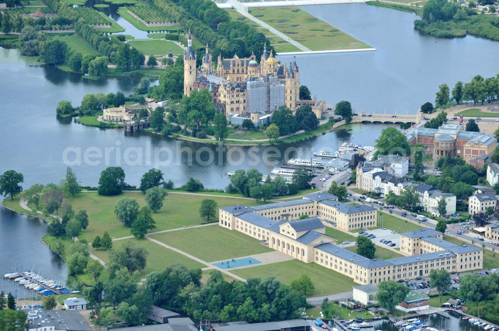 Aerial image Schwerin - Blick auf den historischen Marstall in Schwerin. Das aufwendig restaurierte Gebäude befindet sich auf einer Landzunge an der Werderstraße. Er wurde 1837 - 1842 nach Plänen von G. A. Demmler erbaut und diente als Pferdestall und Reithalle für die herzoglichen Pferde. Seit 1997 werden Teile des Gebäudes vom Technischen Museum genutzt. In den Seitenflügeln sind das Sozialministerium und das Ministerium für Bildung, Wissenschaft und Kultur untergebracht. View of the historical marstall in Schwerin.