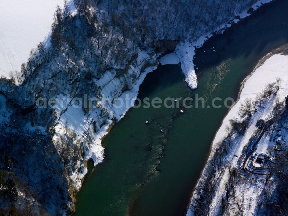 Altötting from above - The river Inn in the county district of Altötting in the state of Bavaria. The river runs along a snow covered, steep rock wall. Further to the East it will run into Austria again