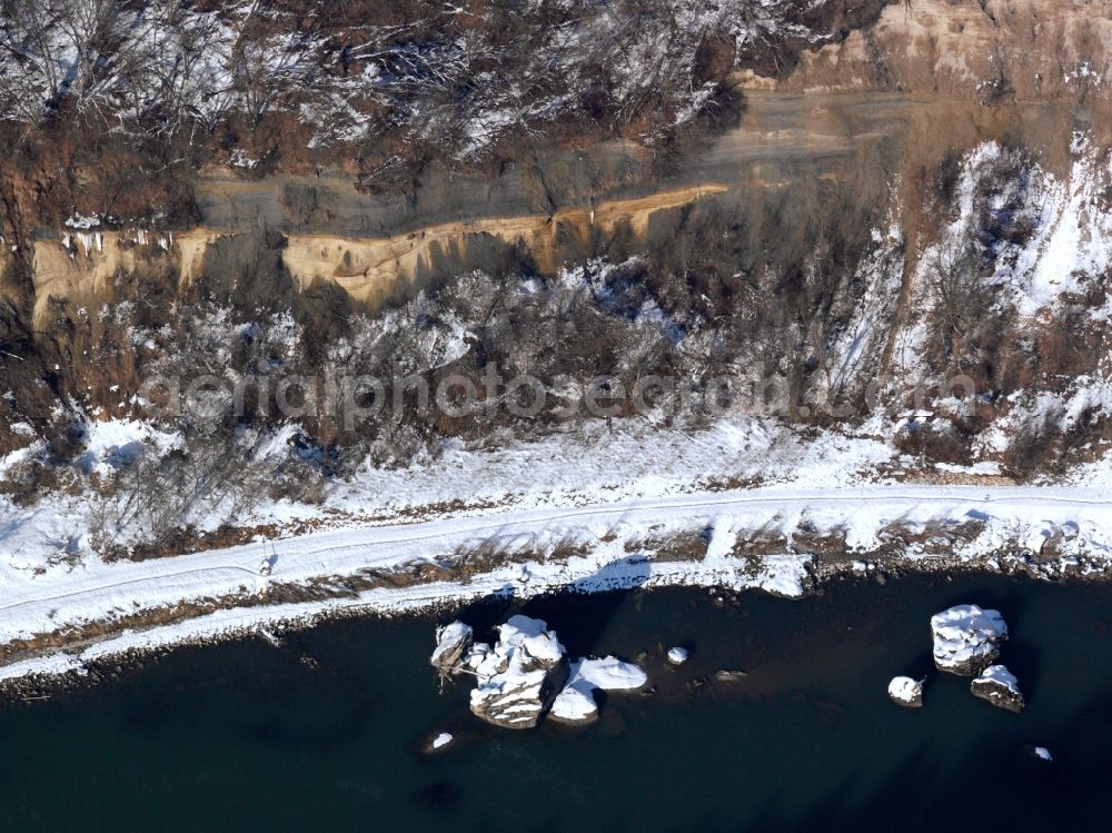 Altötting from the bird's eye view: The river Inn in the county district of Altötting in the state of Bavaria. The river runs along a snow covered, steep rock wall. Further to the East it will run into Austria again