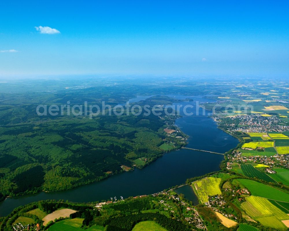 Aerial image Möhnesee - The lake Möhnesee in the county of Möhnesee in the state of North Rhine-Westphalia. The lake is a barrier lake on the river Möhne. It is located on the Nature Park Arnsberger Forest and it is bird protection area as well as nature preserve area in parts. Its dam is officially listed as a protected building