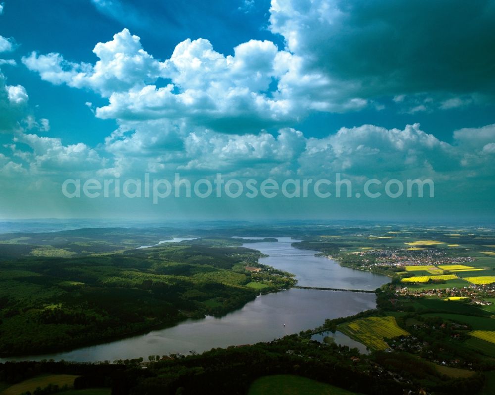 Aerial image Möhnesee - The lake Möhnesee in the county of Möhnesee in the state of North Rhine-Westphalia. The lake is a barrier lake on the river Möhne. It is located on the Nature Park Arnsberger Forest and it is bird protection area as well as nature preserve area in parts. Its dam is officially listed as a protected building