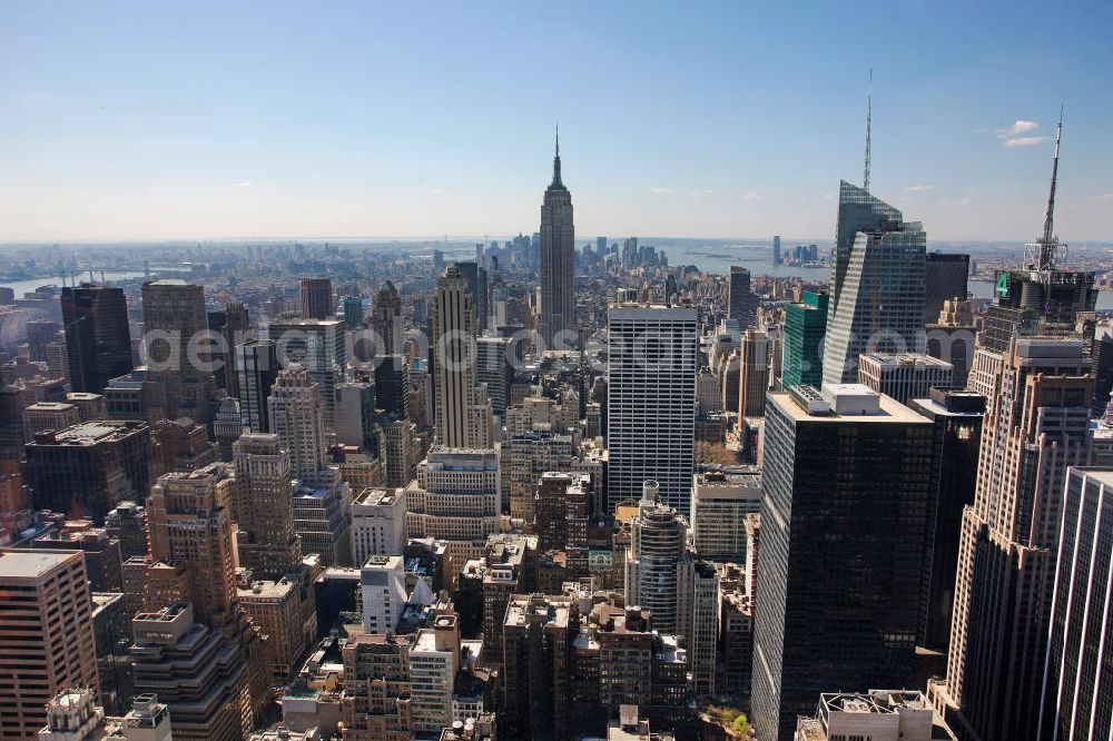 New York from above - View of the Midtown district of Manhattan in New York with the Empire State Building, the Bank of America Tower and the Rockefeller Center. The Plaza District is an important financial district in New York City and is considered as the largest commercial center of the United States