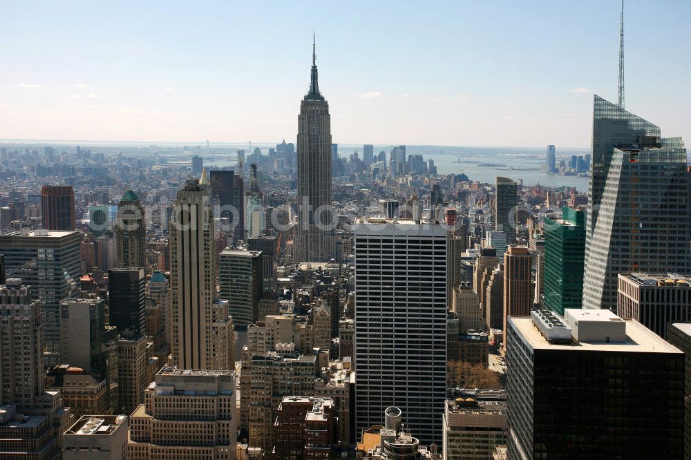 New York from the bird's eye view: View of the Midtown district of Manhattan in New York with the Empire State Building, the Bank of America Tower and the Rockefeller Center. The Plaza District is an important financial district in New York City and is considered as the largest commercial center of the United States