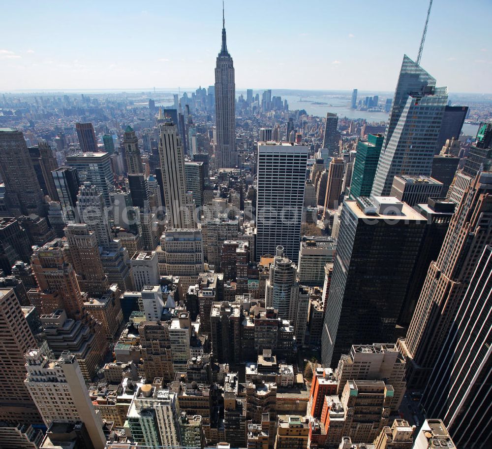 New York from the bird's eye view: View of the Midtown district of Manhattan in New York with the Empire State Building, the Bank of America Tower and the Rockefeller Center. The Plaza District is an important financial district in New York City and is considered as the largest commercial center of the United States