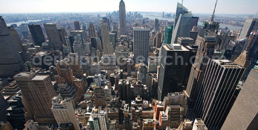 Aerial image New York - View of the Midtown district of Manhattan in New York with the Empire State Building, the Bank of America Tower and the Rockefeller Center. The Plaza District is an important financial district in New York City and is considered as the largest commercial center of the United States