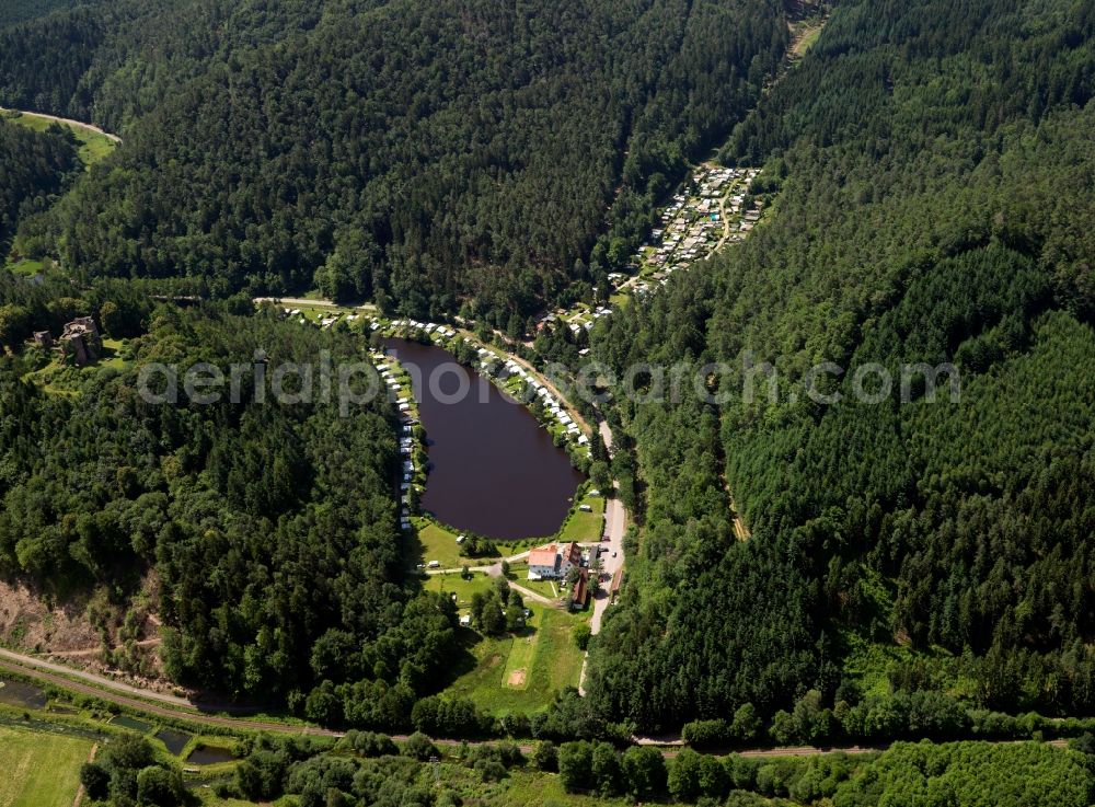 Dahn from above - The lake of Neudahn in the town of Dahn in the state of Rhineland-Palatinate. The small lake is surrounded by a camping site and located in the rock land of Dahn in the Palatinate Forest in the North of the town. The area is a renowned climatic spa