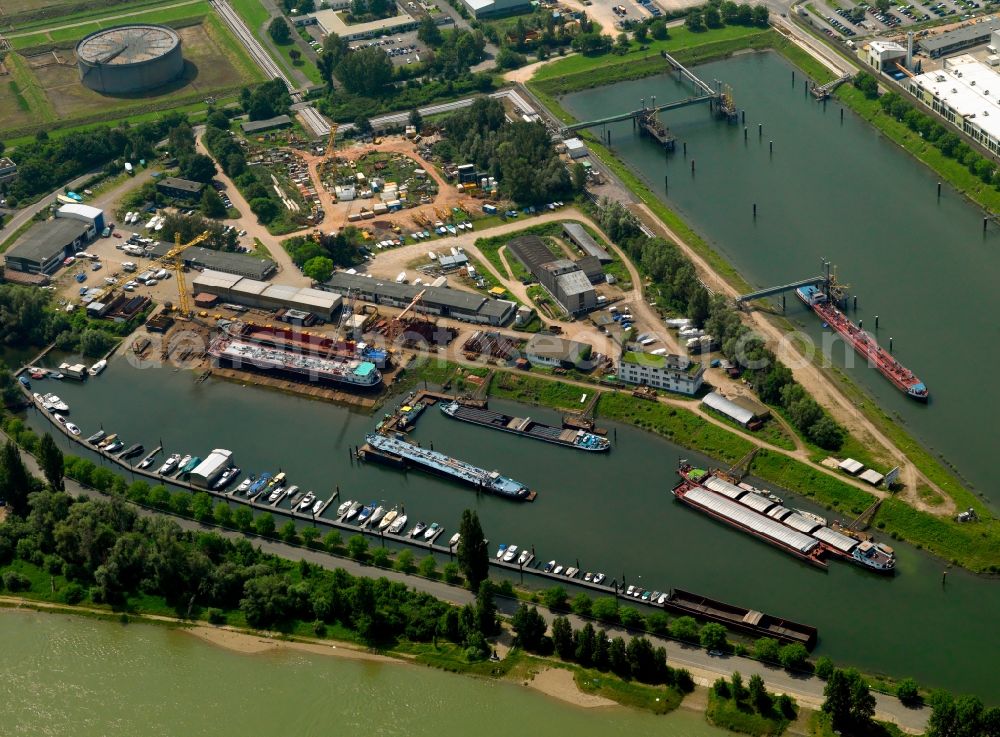 Speyer from above - The New Rhine harbour in the East part of Speyer in the state of Rhineland-Palatinate. The industrial harbour is located on the river Rhine. Speyer is an important town of the Rhine-Neckar metropolitan region. After its regulation, the landscape surrounding the Rhine is still characterised by old and disused river arms. The river also forms the border to the state of Baden-Württemberg