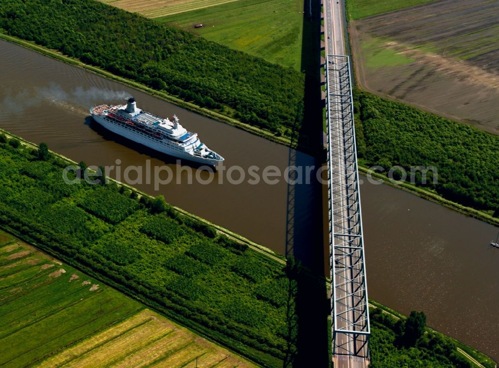 Aerial image Dithmarschen - The North-East Sea Channel in Dithmarschen in the state of Schleswig-Holstein. The channel is the most used artificial water way in the world. It runs throught the landscape which is mostly informed by fields and is used by various ships. View of a car bridge and passanger ship