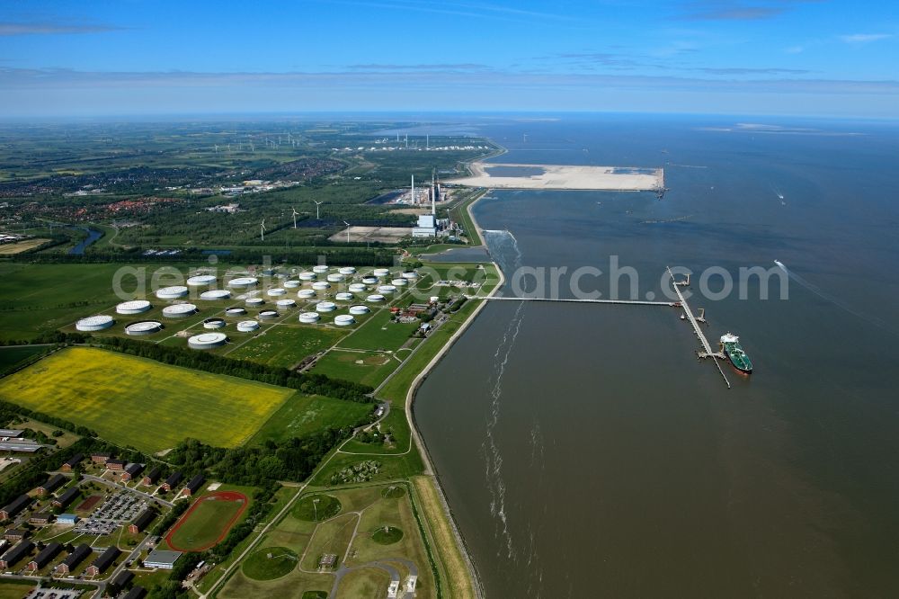 Wilhelmshaven from the bird's eye view: The NWO-oil port in the industrial area of the Rüstersieler Groden and the Voslapper Groden in the city of Wilhelmshaven in the state of Lower Saxony. The port belongs to the Nord-West Oelleitung GmbH. Its main purpose is the saving and distribution of mineral oil and gasoline. There are several industrial sites and power stations in the coastal region of the bay of Wilhelmshaven, which make the area an important infrastructure site