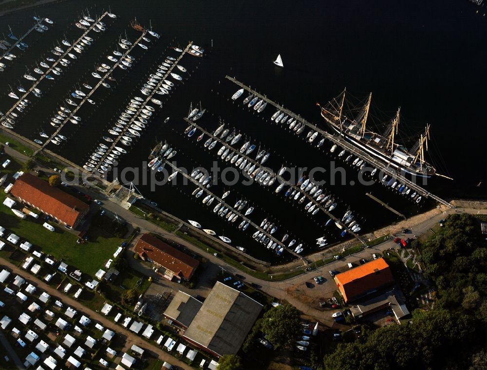 Lübeck from the bird's eye view: The Priwall harbour in the Travemünde part of Lübeck in the state of Schleswig-Holstein. The harbour is located at the river Trave on the mouth to the Baltic Sea. The harbour is on the Eastern riverbank on the peninsula of Priwall. It is primarily a yacht port, also used for sailing ships and ferries