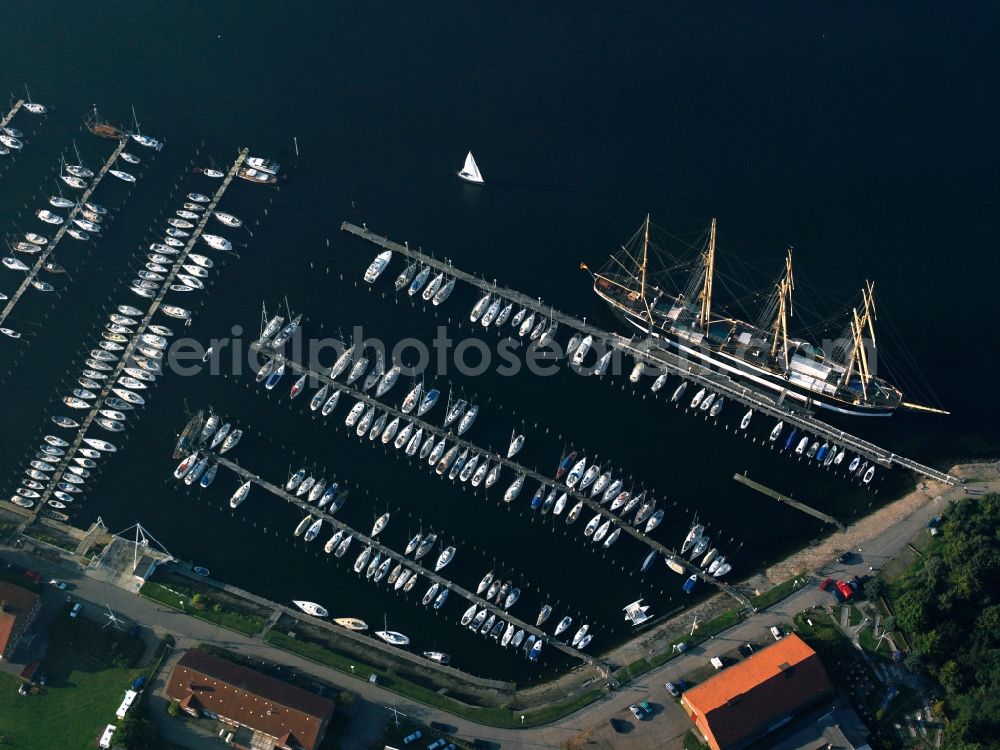 Aerial photograph Lübeck - The Priwall harbour in the Travemünde part of Lübeck in the state of Schleswig-Holstein. The harbour is located at the river Trave on the mouth to the Baltic Sea. The harbour is on the Eastern riverbank on the peninsula of Priwall. It is primarily a yacht port, also used for sailing ships and ferries