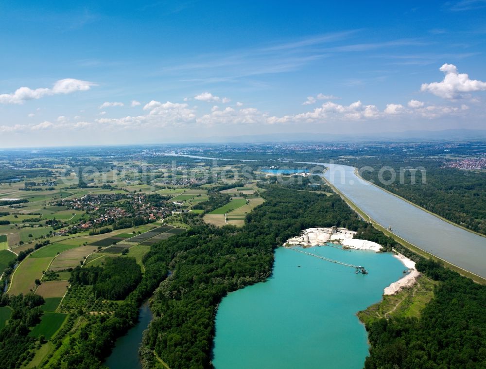 Kehl from above - The river Rhine at the city of Kehl in the state of Baden-Württemberg. In the overview visible is the run of the river through the landscape. The Rhine is the border to France in that area and is important for shipping and transportation and is surrounded by woods, small lakes and fields. The focus lies on the artificial pond Rheinau-Honau