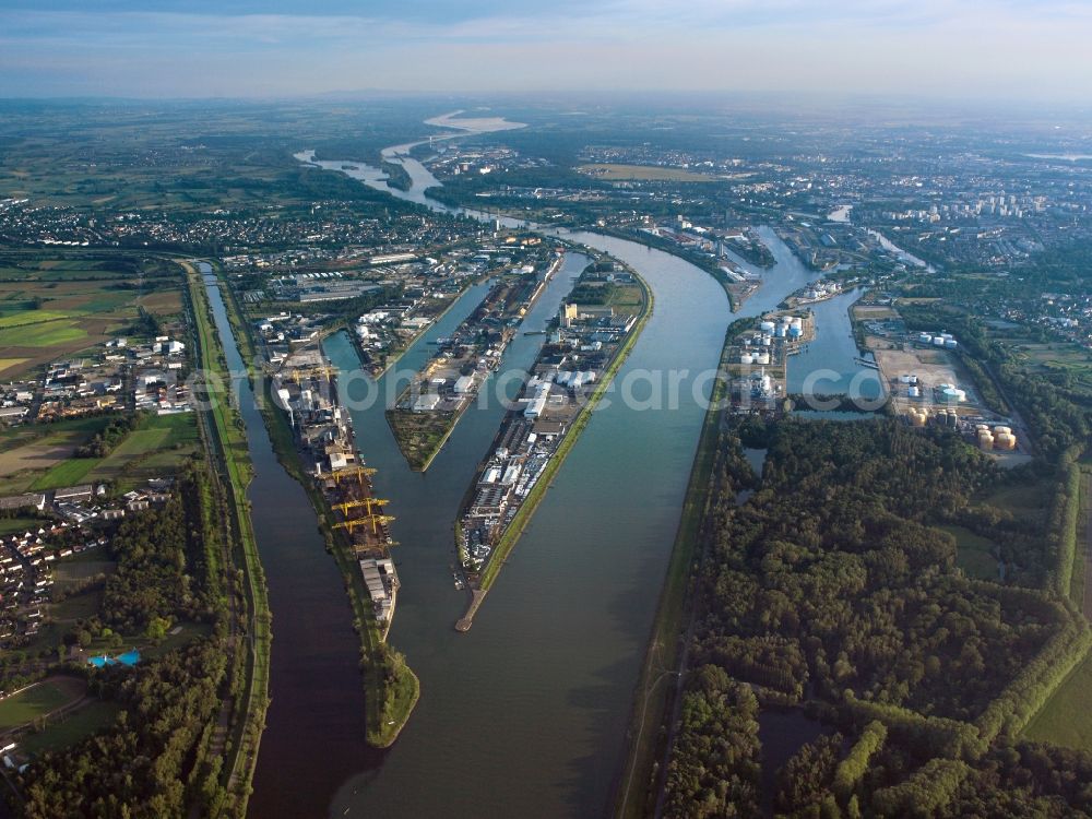 Aerial photograph Kehl - The Rhine port in Kehl in the state of Baden-Württemberg. The port is located in the North of the city opposite the port of Strasbourg on the french side of the Rhine. It has been in place since 1842 and consists of 3 harbour pools and basins with a length of 12 km and a network of 42 km rail. The cargo handling is mainly on steel and iron goods