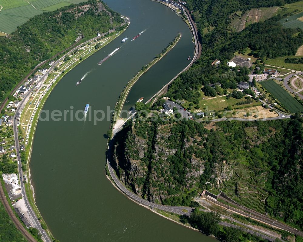 Sankt Goarshausen from the bird's eye view: The shale rock Loreley on the Eastern Rhine shore in Sankt Goarshausen in the state of Rhineland-Palatinate. The rock causes a narrow passage of the river which runs in tight corners through the valley. Because of this, the region is renowned as being dangerous for shipping and boats and from time to time there are accidents. The rock itself is a beloved tourist and trip target