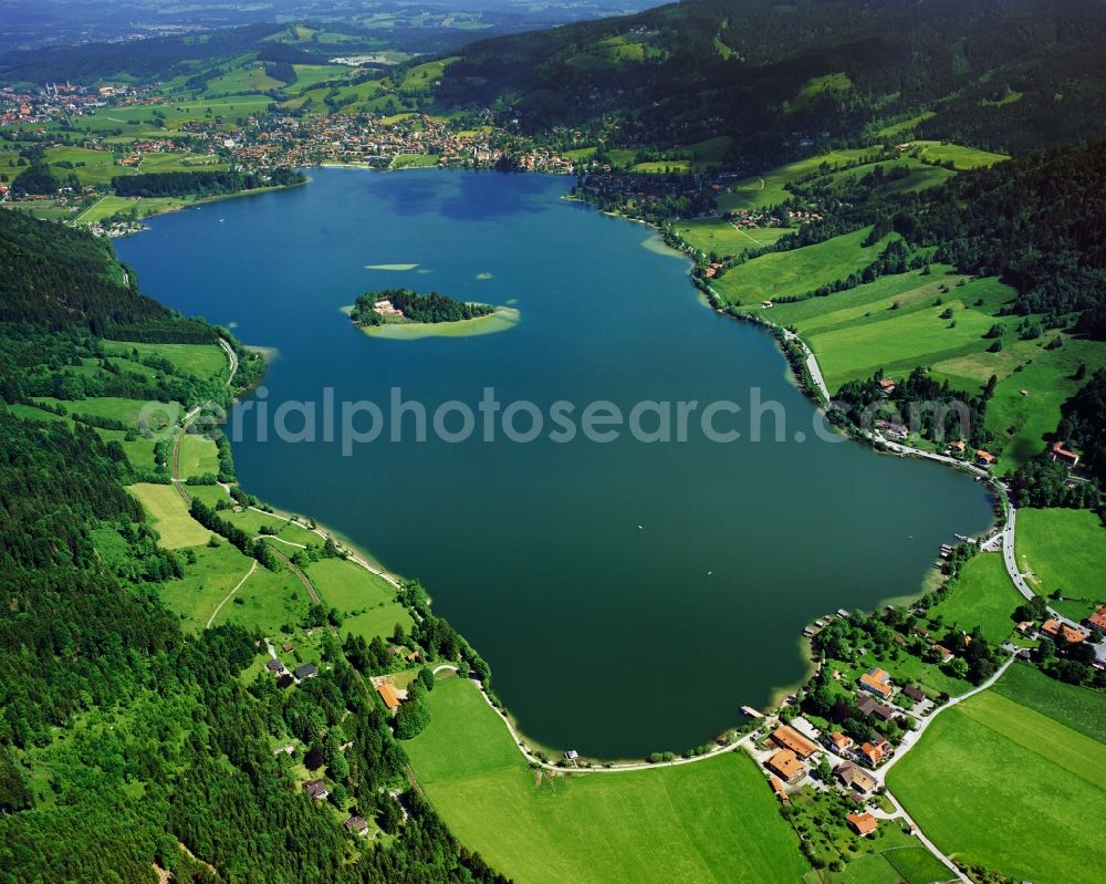 Schliersee from above - Lake Schliersee in the Bavarian Alps in the borough of Schliersee in the state of Bavaria. View from Fischhausen in the South to the borough of Schliersee in the North. The lake with its island is a beloved recreational area and site of sports events like the Alps-Triathlon. In the summer months the Wolfgang Gerberely run local shipping company offers cruises on a liner