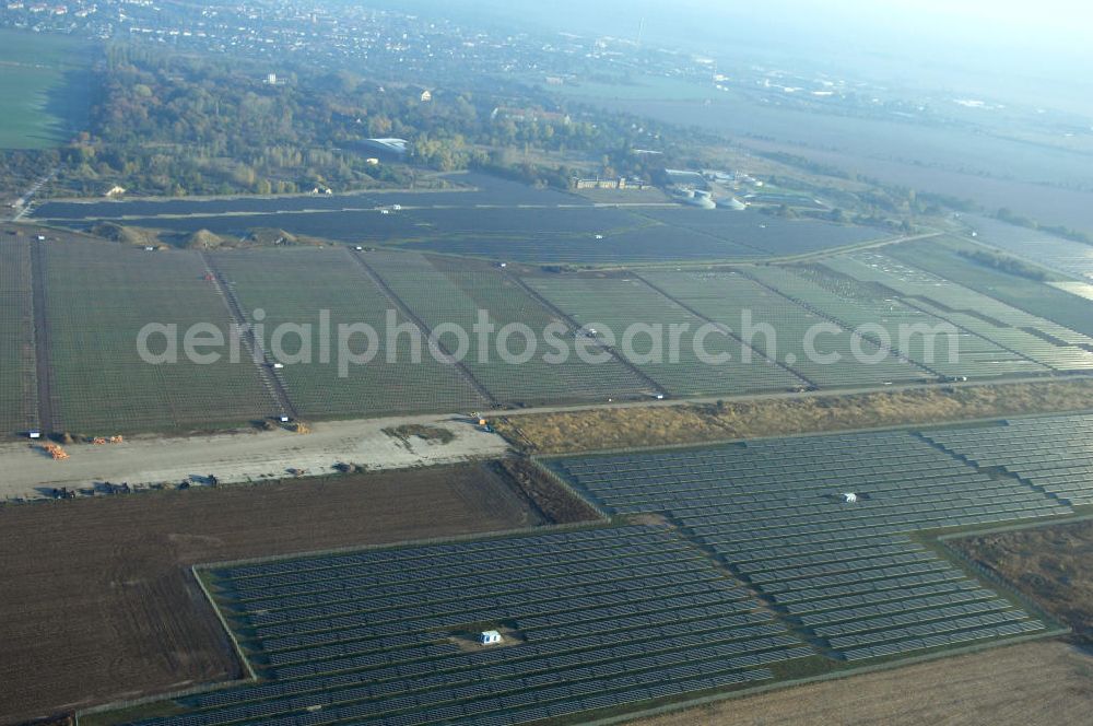 Aerial image Köthen - Blick auf den Solarpark. Auf einer Fläche von 55 Hektar ist es das bundesweit zweitgrößte Photovoltaik-Kraftwerk und wurde 2008 in Betrieb genommen. Die hochmoderne PV-Anlage besteht aus ca. 200.000 dünnschicht Solarmodulen der Firma First Solar. Betrieben wird das Feld von der juwi solar GmbH. Kontakt: juwi Holding AG, Energie-Allee 1, 55286 Wörrstadt, Tel. 06732 / 96 57- 0,