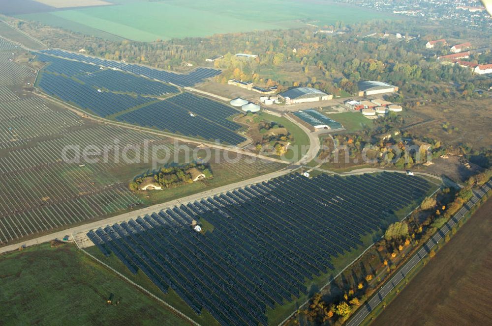 Aerial photograph Köthen - Blick auf den Solarpark. Auf einer Fläche von 55 Hektar ist es das bundesweit zweitgrößte Photovoltaik-Kraftwerk und wurde 2008 in Betrieb genommen. Die hochmoderne PV-Anlage besteht aus ca. 200.000 dünnschicht Solarmodulen der Firma First Solar. Betrieben wird das Feld von der juwi solar GmbH. Kontakt: juwi Holding AG, Energie-Allee 1, 55286 Wörrstadt, Tel. 06732 / 96 57- 0,